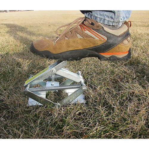 Sturdy metal mole trap set partially underground, demonstrating foot-activated spring mechanism, ideal for Farm, Garden & Tool, Pest Control, and USA Made collections.