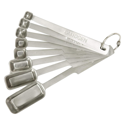 Set of eight stainless steel measuring spoons with elongated deep bowls, including smidgen, pinch, and dash sizes, designed for precise kitchen use in baking and food prep collections.