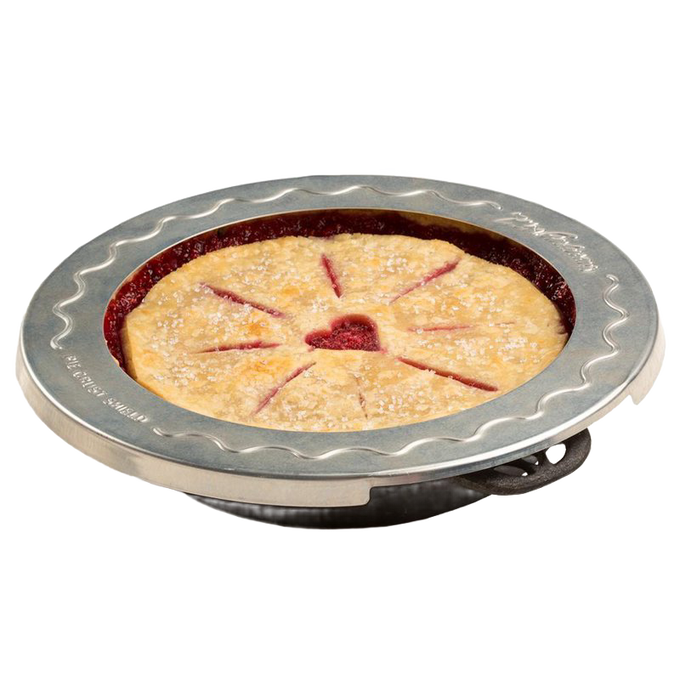 Round aluminum pie crust shield with scalloped edge placed on a pie to prevent crust burning, fits 10-inch pies, ideal for Kitchen & Food, Baking Supplies, and Cooking Helpers collections.