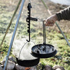 Hand gripping a steel lid lifter tool to safely remove a hot Dutch oven lid over an outdoor campfire, featured in Farm, Garden & Tool, Camping, and Best Sellers collections.