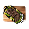 Handcrafted lightweight cast iron double burner griddle with perfectly sliced flank steak, grilled scallions, and lemon wedges on a wooden cutting board, ideal for Kitchen & Food and Cast Iron collections.
