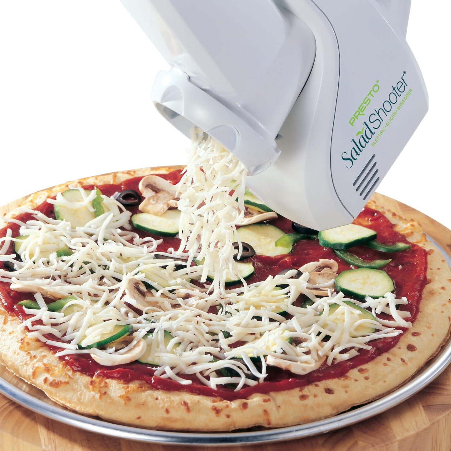 Electric kitchen gadget shredding cheese directly onto a vegetable-topped pizza crust, ideal for quick meal prep in Kitchen & Food, Food Prep, and Cooking and Baking Helpers collections.