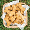 Basket filled with handcrafted bone-shaped dog treats made from a healthy mix, displayed on grass, suitable for Home & Decor, Pet Supplies, and Best Sellers collections.