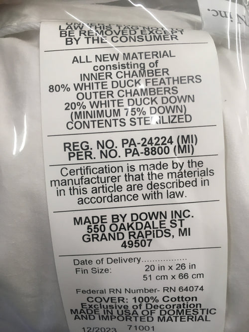 Close-up of a label on a layered feather and down pillow detailing 80% white duck feathers and 20% white duck down filling, with cotton cover, handcrafted in the USA, ideal for Home & Decor, Home Textiles, Best Sellers, and Promo Eligible collections.