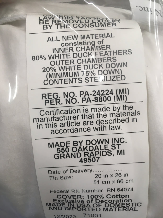 Close-up of a label on a layered feather and down pillow detailing 80% white duck feathers and 20% white duck down filling, with cotton cover, handcrafted in the USA, ideal for Home & Decor, Home Textiles, Best Sellers, and Promo Eligible collections.