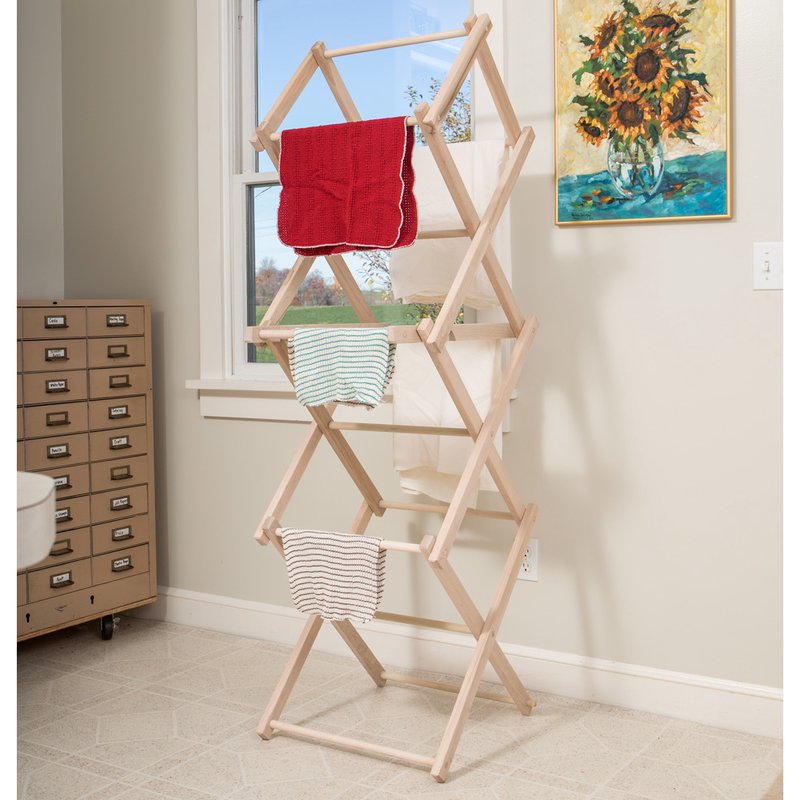 Tall adjustable wooden clothes drying rack with three fabric pieces draped over it, handcrafted by Amish makers, ideal for compact spaces in laundry and home decor.