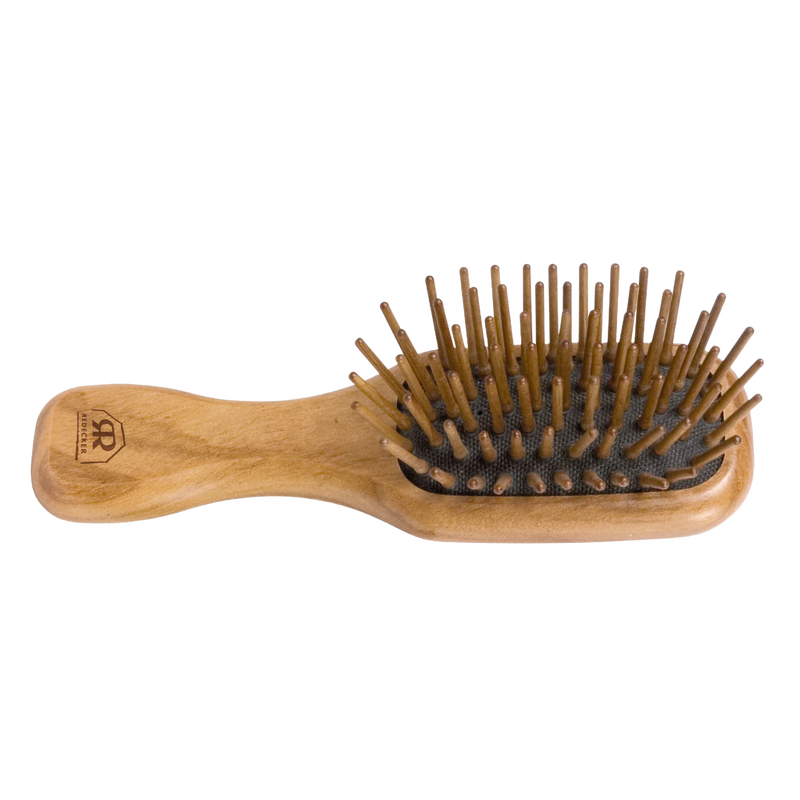 Handcrafted compact hairbrush with olive wood handle and seven rows of straight hornbeam pins for gentle detangling, featured in Health & Wellness, Grooming, and Best Sellers collections.