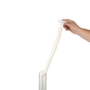 Hand holding a flexible foam brush with a textured cleaning head inserted into a clear oil lamp chimney, designed for gentle and thorough cleaning of glass chimneys, USA made accessory.