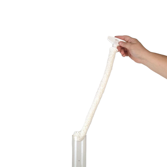 Hand holding a flexible foam brush with a textured cleaning head inserted into a clear oil lamp chimney, designed for gentle and thorough cleaning of glass chimneys, USA made accessory.