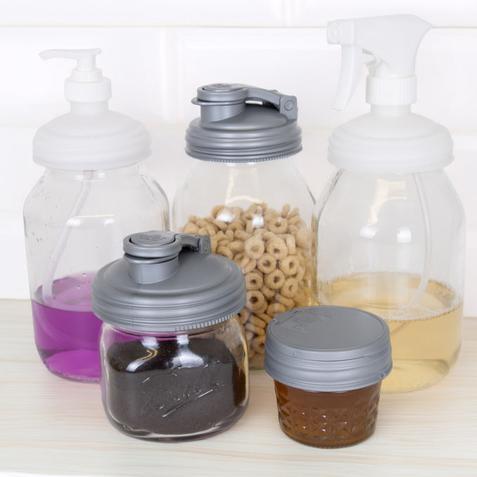 Set of five handmade reusable gray reCAP lids on Mason jars and bottles, including pump and spray tops, ideal for eco-conscious kitchens in Home & Decor, Household Helpers, USA Made, and Best Sellers collections.
