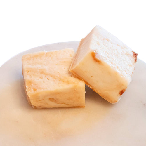 Two handcrafted creamy beige fudge pieces with a smooth, melt-in-your-mouth texture on a light marble plate, featured in Kitchen & Food, Snacks and Sweets, USA Made, and Best Sellers collections.
