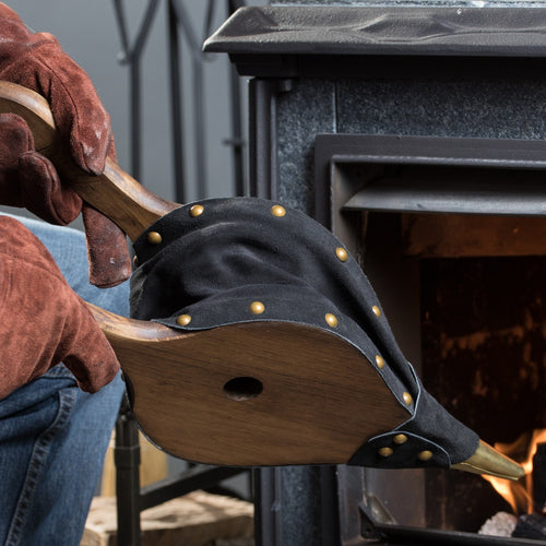 Handcrafted leather bellows with stained pine wooden handles and solid brass nozzle, used to stoke a fire in a stove, made in USA, ideal for hearth accessories and stove collections.