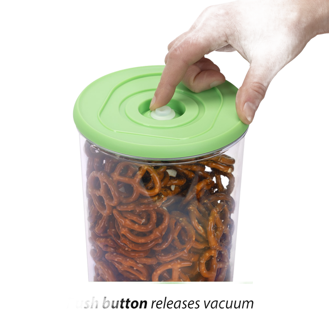 Hand pressing the valve on a green lid sealing a clear vacuum container filled with pretzels, designed for food preservation in Kitchen & Food and Storage collections.
