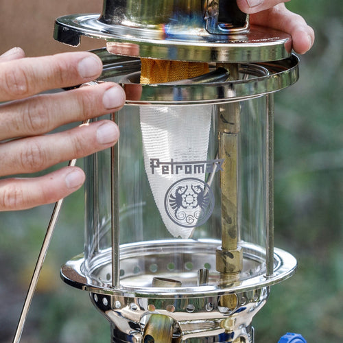 Close-up of hands installing a durable, rounded replacement mantle inside a high-pressure lantern, featured in Lamps & Lighting, Parts and Accessories, Wicks and Mantles, Best Sellers, and Promo Eligible collections.