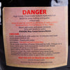 Warning label on a resealable bag of high-grade food-grade sodium hydroxide lye beads with safety instructions, first aid measures, and handling precautions for soapmaking use.