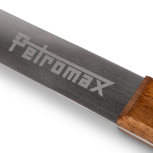 Close-up of a handcrafted stainless steel ladle handle with a detailed Petromax engraving and smooth wooden grip, designed for durability in Farm, Garden & Tool, Camping, and Kitchen & Food collections.