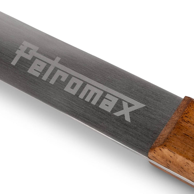Close-up of a handcrafted stainless steel ladle handle with a detailed Petromax engraving and smooth wooden grip, designed for durability in Farm, Garden & Tool, Camping, and Kitchen & Food collections.