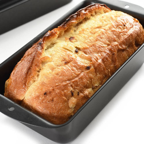 Golden-browned loaf baking in dark non-stick pan with smart design for healthier cooking, ideal for Kitchen & Food, Cookware, Baking Supplies, and Best Sellers collections.