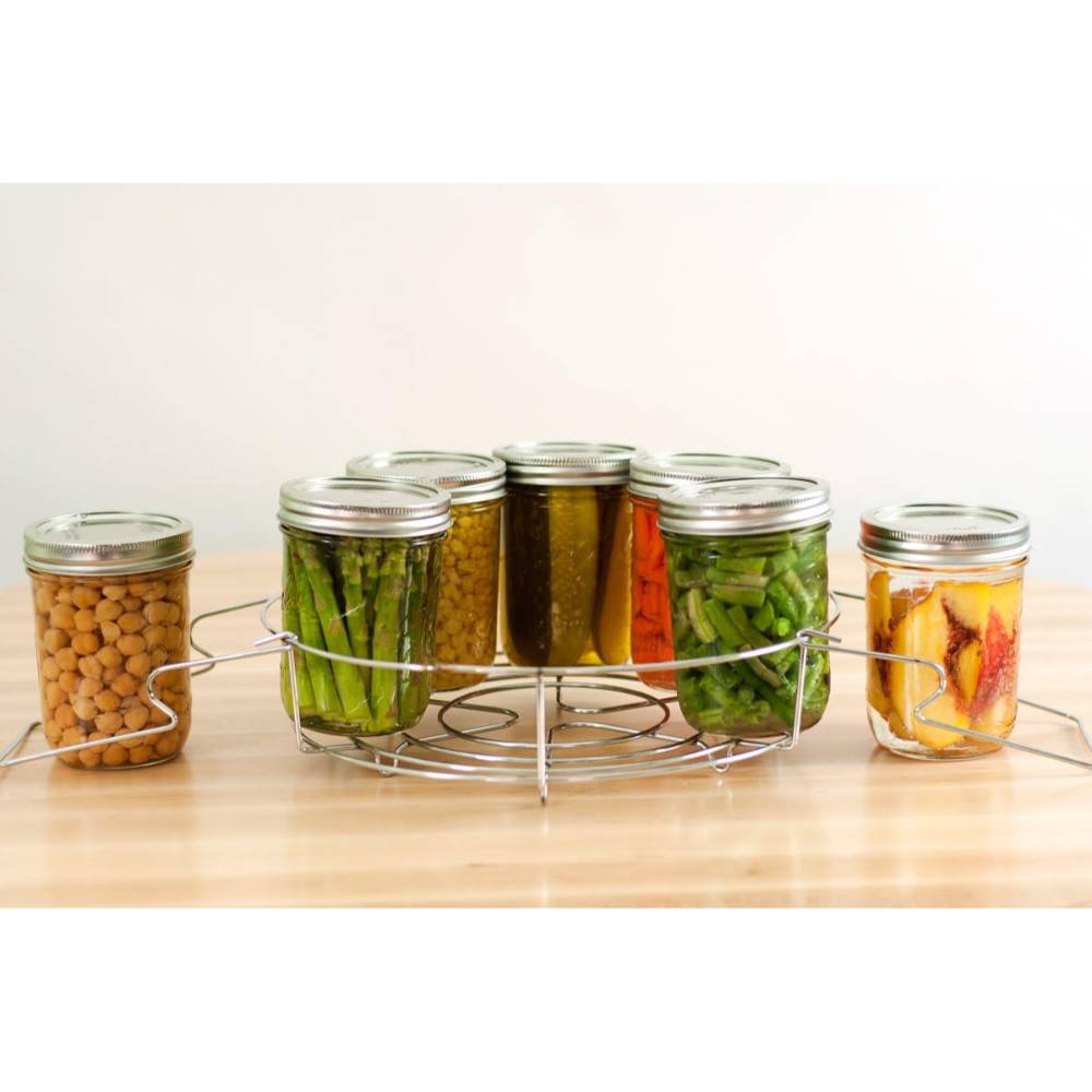 Chrome wire rack with contoured handles holding eight glass canning jars filled with preserved vegetables and fruits, featured in Kitchen & Food, Food Preservation, and Canning Accessories collections.