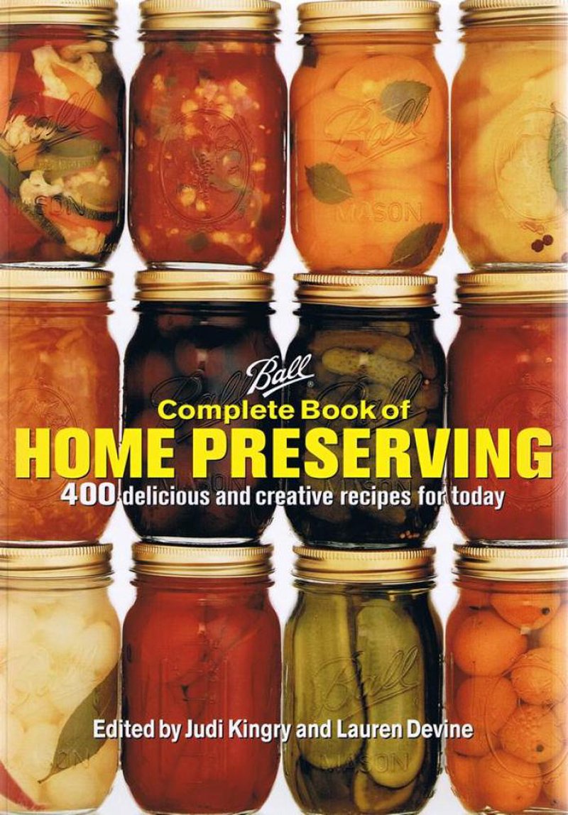 Cover of a handcrafted home preserving cookbook featuring nine mason jars filled with colorful preserved fruits and vegetables, ideal for Books, Canning and Preserving Books, and Best Sellers collections.