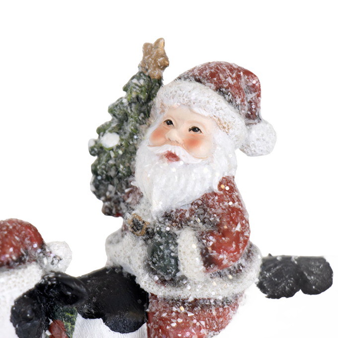 Charming handcrafted resin Santa figurine holding a Christmas tree, surrounded by snow accents, adding festive cheer to Home & Decor, Holiday Decor, Best Sellers, and Promo Eligible collections.