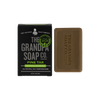 Bar of pine tar soap with embossed logo beside black box featuring vintage-style branding and green seal, natural and vegetable-based, part of Health & Wellness, Soaps, and USA Made collections.