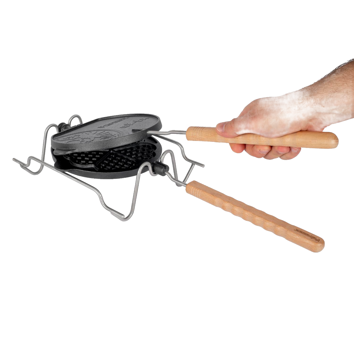 Handcrafted cast iron rotating waffle iron with wooden handles resting on a folding metal stand, designed for outdoor camping, farm, garden, and tool enthusiasts.