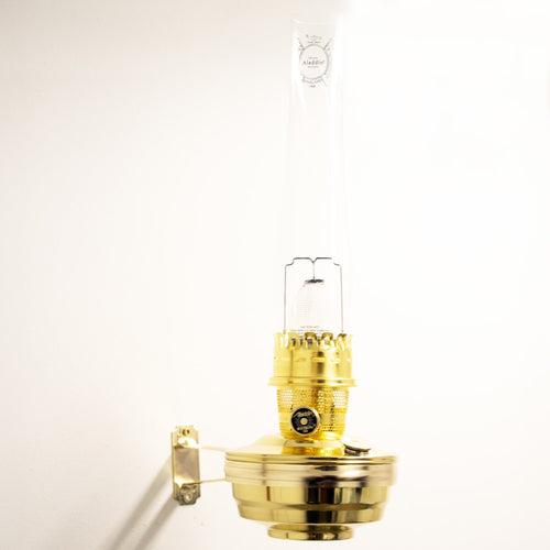 Handcrafted solid brass wall-mounted oil lamp with clear glass chimney, designed for bright, reliable light in farm, garden, emergency, and lamps & lighting collections.