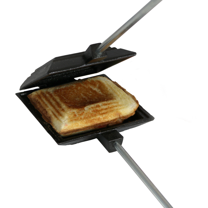 Cast iron square pie iron with metal handle and wooden grips, toasting a sandwich, ideal for camping and included in Farm, Garden & Tool, Best Sellers, and Promo Eligible collections.