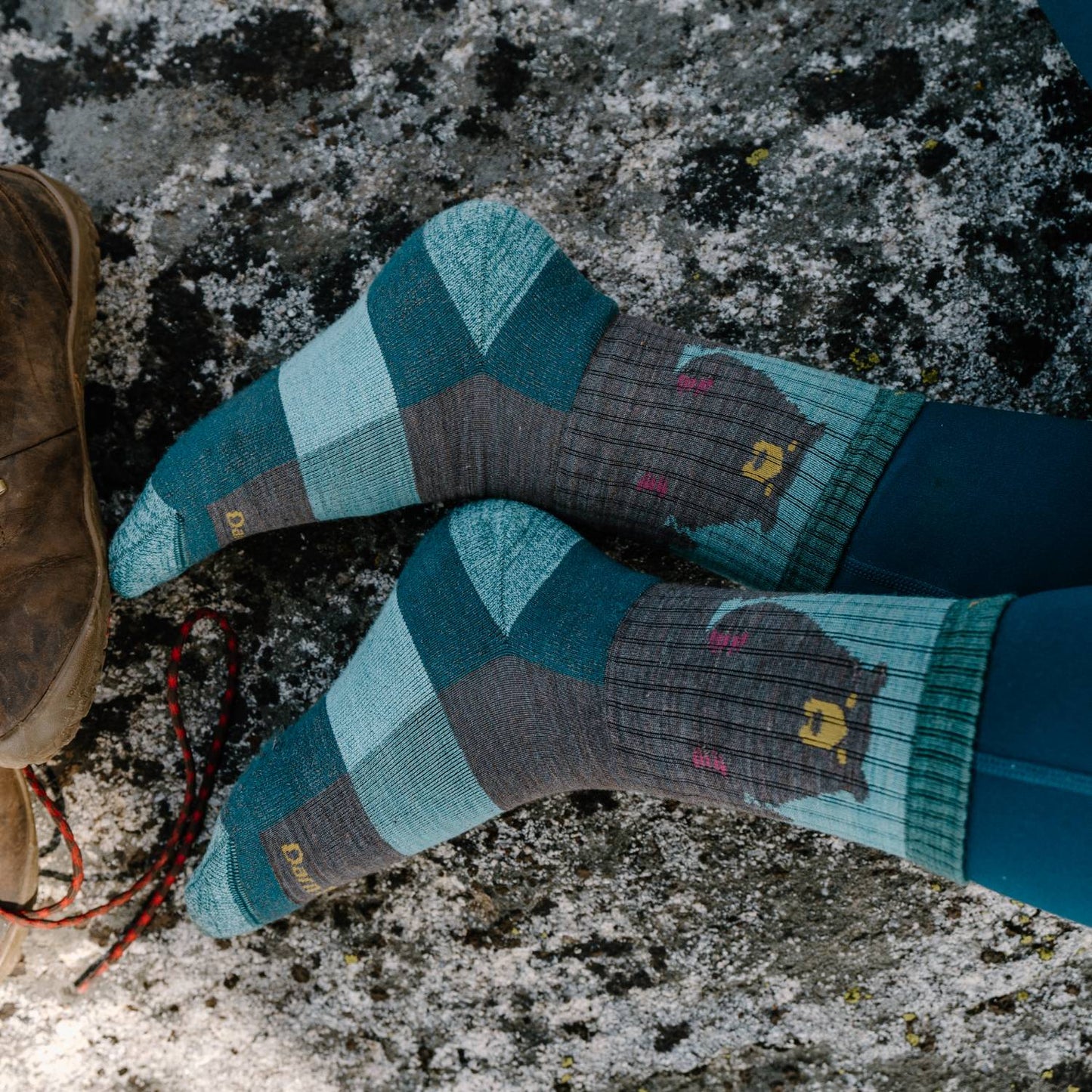 Pair of lightly cushioned hiking socks with a colorful geometric pattern and a bear graphic, designed for comfort during outdoor activities, featured in USA Made and Camping collections.