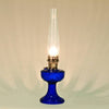Handcrafted cobalt blue glass oil lamp with detailed drape font design and clear glass chimney, perfect for Lamps & Lighting, Oil Lamps, Table Lamps, Best Sellers, and Promo Eligible collections.