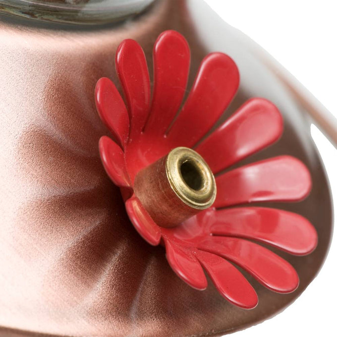 Close-up of red flower-shaped feeding port with brass center on copper base of a hummingbird feeder, part of Farm, Garden & Tool, Animal Care, and Best Sellers collections.
