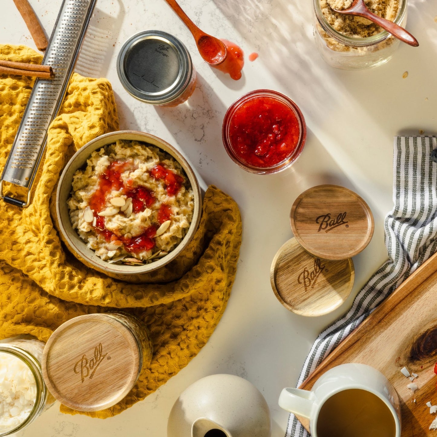 Three handcrafted acacia wood airtight lids with engraved branding, shown alongside breakfast ingredients and utensils, ideal for Kitchen & Food and Storage and Serving collections.