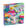 Colorful sewing craft kit box featuring felt fabric pieces, thread, measuring tape, buttons, and child-friendly sewing projects, perfect for children's arts and crafts and toy collections.