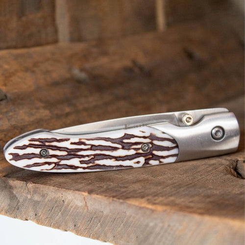 Folding knife with a textured antler handle and stainless steel lockback mechanism, handcrafted for durability and practical use, featured in Farm, Garden & Tool and Pocket Knives collections.