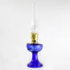 Handcrafted cobalt glass oil lamp with brass burner and tall clear chimney, featuring a vintage design, ideal for Lamps & Lighting, Oil Lamps, Table Lamps, Best Sellers, and Promo Eligible collections.