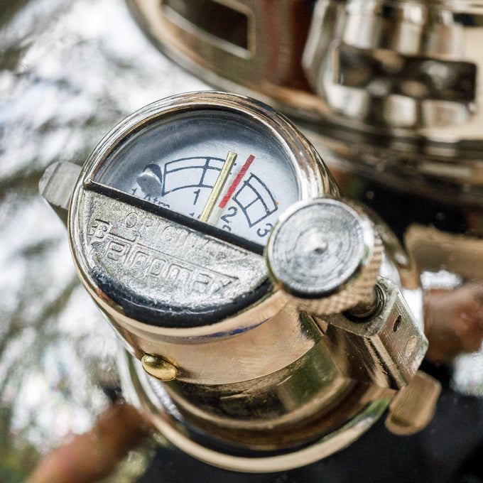 Close-up of a shiny metal manometer gauge with a clear dial and red pressure zone, designed for pressure lamps, featured in Lamps & Lighting, Parts and Accessories, and Best Sellers collections.