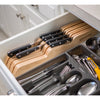 Wooden drawer organizer holding seven Wusthof knives with black handles neatly arranged next to a utensil tray, featured in kitchen accessories and food prep collections.