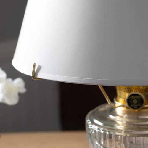 Close-up of a smooth white parchment lamp shade on a clear glass oil lamp base, ideal for Lamps & Lighting, Parts and Accessories, Lamp Shades, Best Sellers, and Promo Eligible collections.