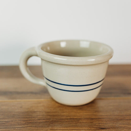 Handcrafted stoneware bowl with a handle, featuring natural color and two blue stripes, perfect for Kitchen & Food, Dinnerware, USA Made, Best Sellers, and Promo Eligible collections.