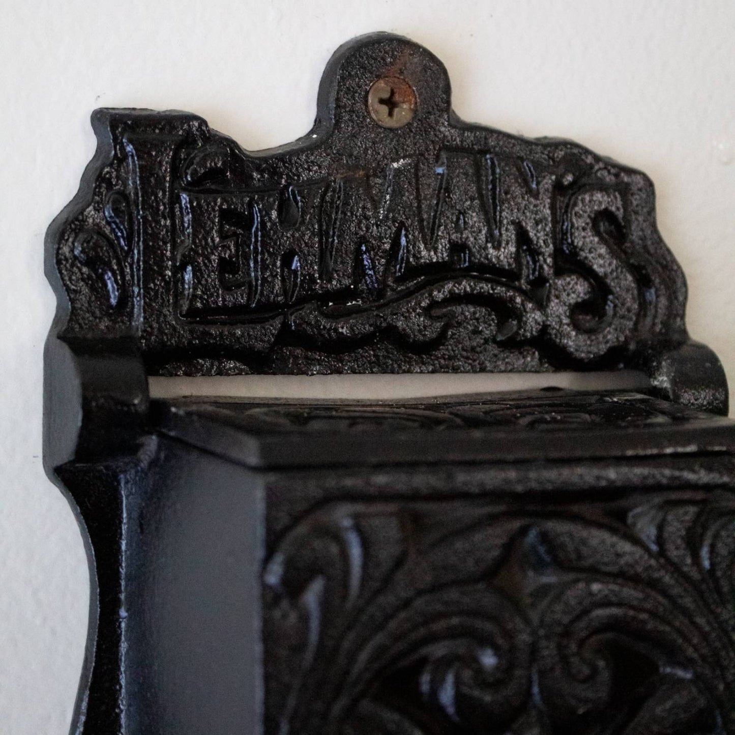 Handcrafted black cast iron wall-mounted matchbox holder with vintage decorative scrollwork and Lehman's branding, made in USA, featured in Home & Decor and Best Sellers collections.