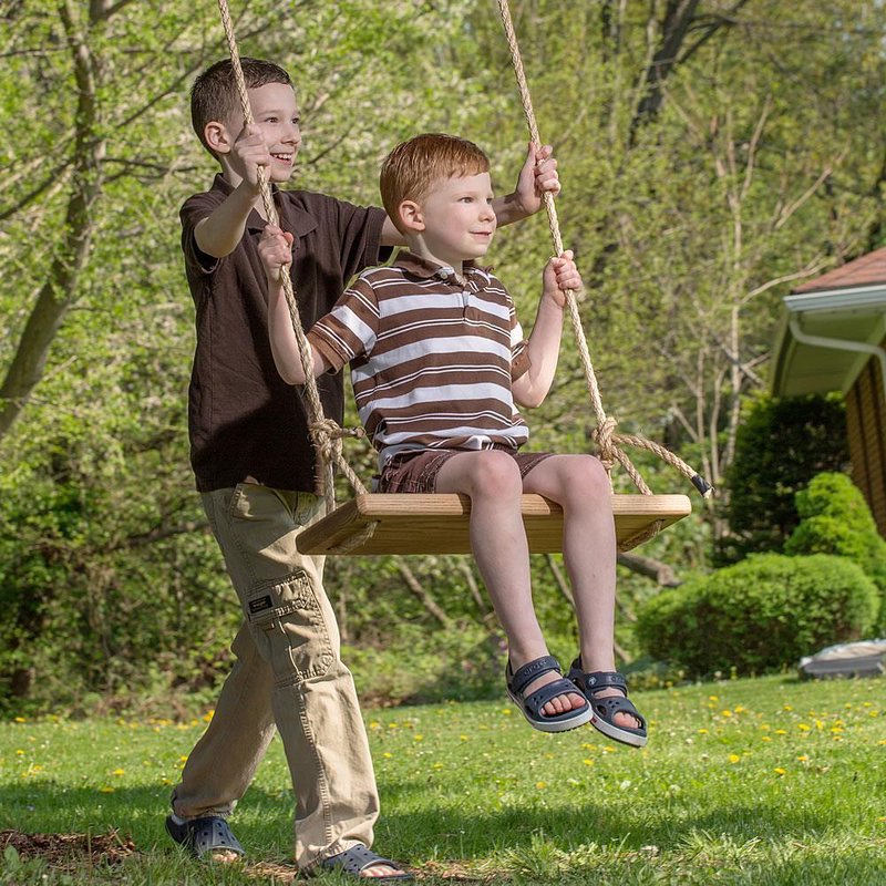 Two boys enjoying outdoor play with a handcrafted wooden rectangle swing made in USA, perfect for children's toys, lawn games, and family fun in fresh air.