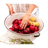 White enamelware basin with black-trimmed handles filled with red and yellow apples, styled for home, garden, camping, and household cleaning use.