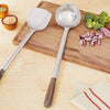 Set of two stainless steel wok utensils with wooden handles, featuring a spatula and ladle, displayed on a wooden cutting board with chopped vegetables, ideal for Kitchen & Food and Kitchen Gadgets collections.