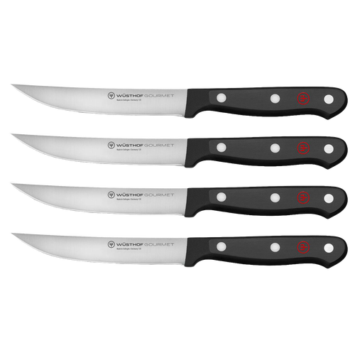 Set of four high-carbon stainless steel steak knives with triple-riveted black synthetic handles, designed for Kitchen & Food, Knives & Axes, and Best Sellers collections.