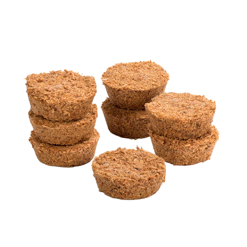 Eight handcrafted Fatwood Firedrops made from natural sawdust and paraffin, arranged in small stacked piles, perfect for camping, emergency supplies, and outdoor fire-starting.