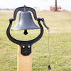 Black cast aluminum farm bell mounted on wooden post with pull rope, set outdoors in a rural landscape, ideal for Home & Decor, Farm, Garden & Tool, and Amish Made collections.