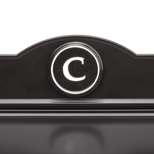 Close-up of a handcrafted black and white custom wall mount mailbox featuring a raised circular monogram letter "C," designed to enhance curb appeal in Home & Decor and USA Made collections.
