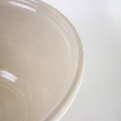 Close-up of a handcrafted stoneware mixing bowl in cream with heritage blue stripes, made in the USA, ideal for Kitchen & Food, Cookware, Baking Supplies, and Storage collections.