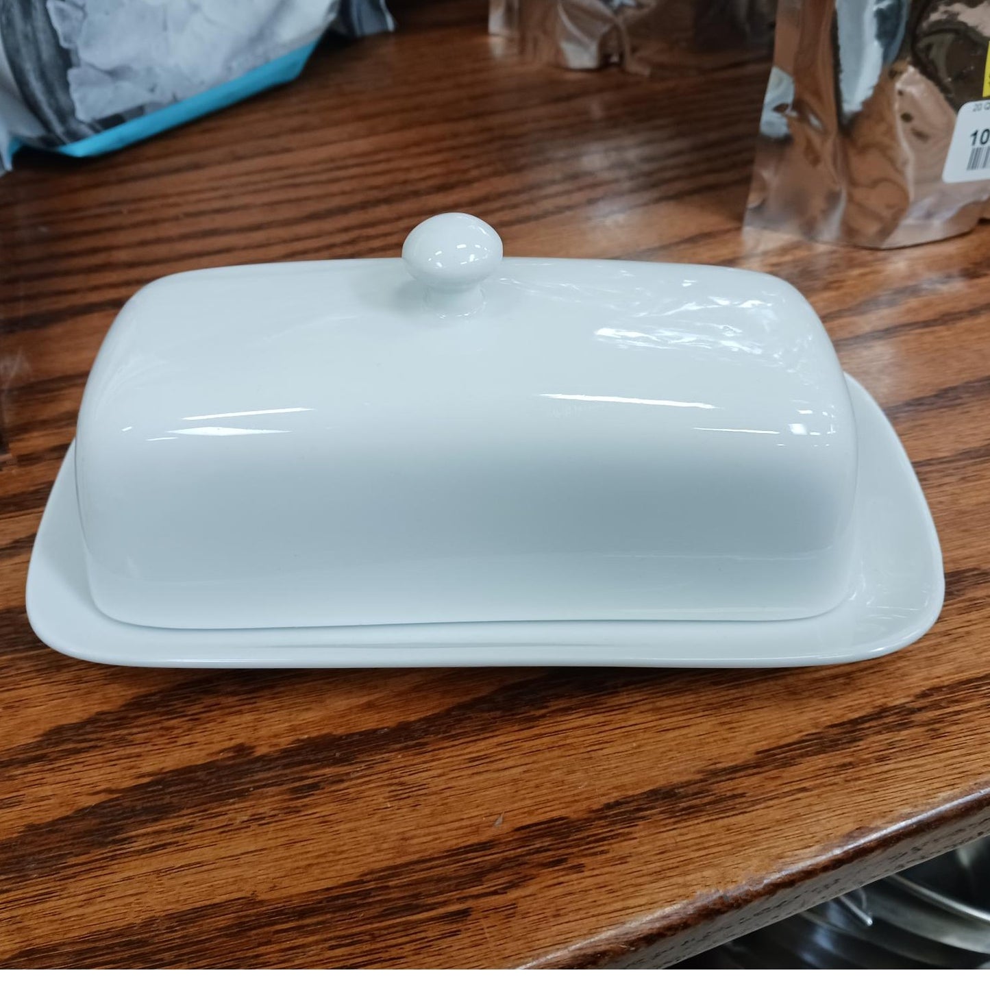 White porcelain butter dish with knob top, durable two-piece design perfect for Kitchen & Food, Specialty Equipment, Making Butter, Storage and Serving, Best Sellers, and Promo Eligible collections.